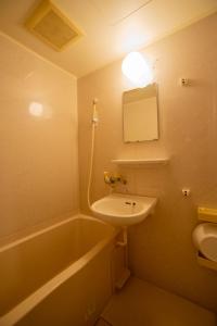 a bathroom with a sink and a bath tub at クリステート503-Crystate 503- in Kyoto