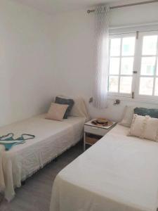 A bed or beds in a room at Calma apartment On the most amazing beach in Fuerteventura