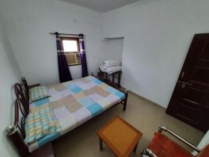 a small bedroom with a bed and a window at Janardan Homestay Lucknow in Lucknow