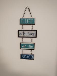 a sign that says life is better at the beach at Villa Playa in Novo Sancti Petri