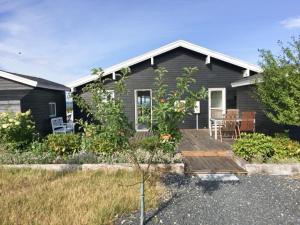 a house with a wooden deck in front of it at Live By Isefjorden In A Home With A View in Skibby