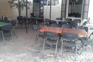 a group of tables and chairs in a room at Orchard Hotel - Standard in Ibadan +17 photos