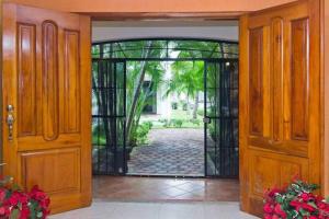 an open door with a view of a courtyard at Sunset Double Room in Stunning Villa Playacar Ii in Playa del Carmen