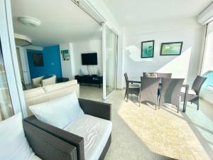 a living room with a couch and a table at Marbella 2bedroom Beachfrom Apt in San Pedro de Macorís