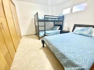 a bedroom with a bed and a bunk bed at Marbella 2bedroom Beachfrom Apt in San Pedro de Macorís +23 photos