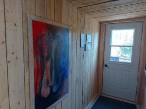 a room with a door and a painting on the wall at Nice accommodation at the Grand Hron in Saint-Fulgence