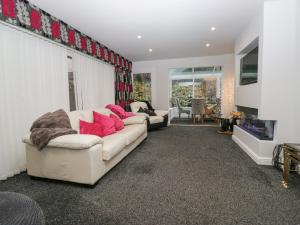 a living room with two couches and a television at Hazelodge in Coniston