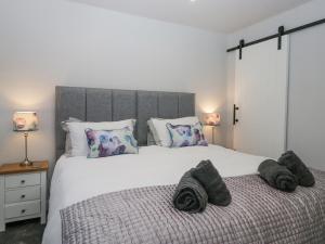 a bedroom with a large white bed with pillows at Hazelodge in Coniston
