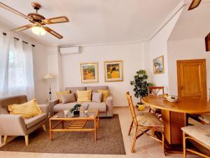 a living room with a couch and a table at Dream Bungalow with Sea Views at La Mata Beach in Torrevieja