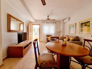 a living room with a table and a couch at Dream Bungalow with Sea Views at La Mata Beach in Torrevieja