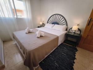 a bedroom with a large bed with towels on it at Dream Bungalow with Sea Views at La Mata Beach in Torrevieja +29 photos