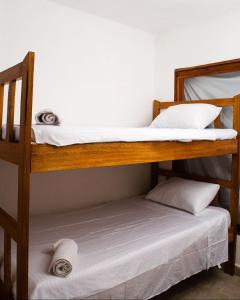 two bunk beds in a room next to a bed at Hb1 Triple Room With Air Conditioning And WIFI in Cartagena de Indias