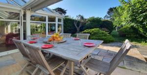 a wooden table with a bowl of fruit on it at La villa les pieds dans leau in Saint-Pierre-Quiberon +21 photos