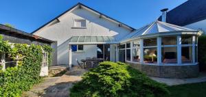 a house with a gazebo on a patio at La villa les pieds dans leau in Saint-Pierre-Quiberon