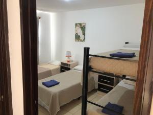 a room with three bunk beds and a mirror at WaraKusi Cottages - Off Road in Salta