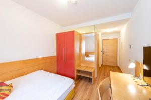 Postel nebo postele na pokoji v ubytování Hotel Figl ***S