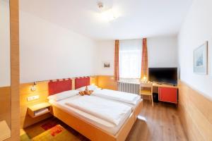 Postel nebo postele na pokoji v ubytování Hotel Figl ***S
