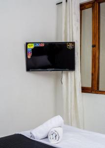 a flat screen tv hanging on a wall at Hb2 Triple Room with shared bathroom in Cartagena de Indias