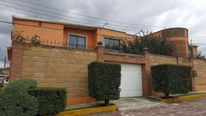 a brick house with a white garage at Almoloya De Juarez Colonial House in Almoloya de Juárez