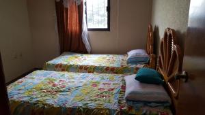 two twin beds in a bedroom with a quilt at Almoloya De Juarez Colonial House in Almoloya de Juárez