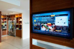 a large television on a wall in a room at Courtyard by Marriott Aberdeen Airport in Dyce