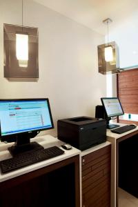 an office with a desk with a computer and a printer at Courtyard by Marriott Aberdeen Airport in Dyce
