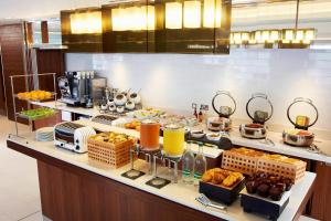 a breakfast buffet in a hotel room with food at Courtyard by Marriott Aberdeen Airport in Dyce