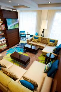 a living room with a couch and a tv at Courtyard by Marriott Aberdeen Airport in Dyce