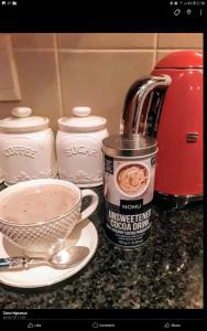 a kitchen counter with a cup of coffee and a mixer at Emmanuel-Guest-House in Richards Bay