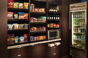 a kitchen with a pantry with food and a refrigerator at Courtyard by Marriott Macon in Macon