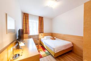 Postel nebo postele na pokoji v ubytování Hotel Figl ***S