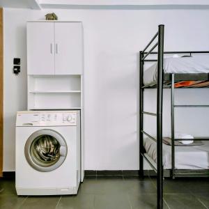 a washing machine in a room with a shelf at Seaside apartment in Agioi Theodoroi
