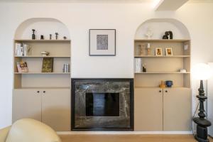 a living room with a fireplace and shelves at Yi Du Home with City View - Family Suite 500m to Nanjing West Rd Near People's Square -Credit Cards Accepted in Shanghai