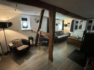 a living room with a loft bed and a couch at Altes Grabenhöfchen - 5 Sterne Ferienhaus in Stetten