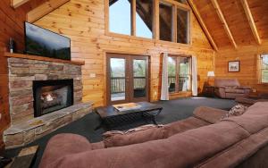 a living room with a couch and a fireplace at Brink of Paradise in Gatlinburg