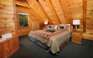 a bedroom with a bed in a log cabin at Brink of Paradise in Gatlinburg