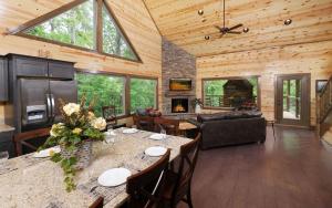 a living room with a table and a fireplace at Rustic Timber in Sevierville