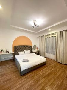 a bedroom with a large white bed and a window at Vinhomes Time City Luxury Apartment in Ha Noi in Hanoi +44 photos