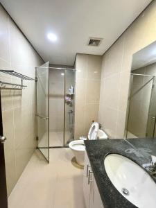 a bathroom with a toilet and a sink and a shower at Vinhomes Time City Luxury Apartment in Ha Noi in Hanoi