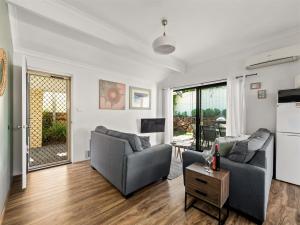 a living room with two couches and a table at Tootys Place in Margaret River Town