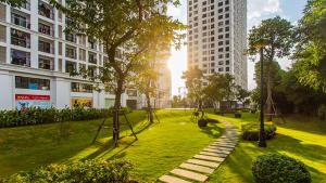 a park in the middle of a city with tall buildings at Vinhomes Time City Luxury Apartment in Ha Noi in Hanoi