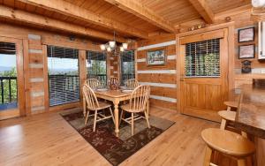 a dining room with a table and chairs at Peak A View in Sevierville