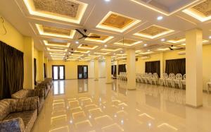 a banquet hall with chairs and tables in a room at Hotel Panna Shree in Ujjain