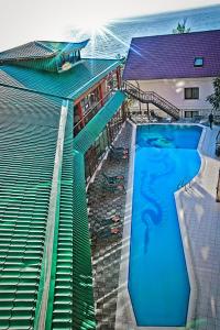an overhead view of a swimming pool next to a building at Veseliy Hotey in Gurzuf