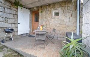 a patio with a table and chairs and a grill at Casa Di Minnana in Petreto-Bicchisano