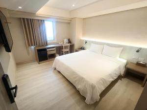 Postel nebo postele na pokoji v ubytování 衿后禾居Good Hotel