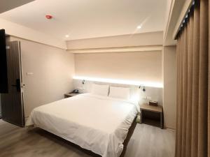 Postel nebo postele na pokoji v ubytování 衿后禾居Good Hotel