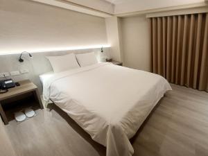 Postel nebo postele na pokoji v ubytování 衿后禾居Good Hotel