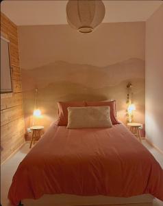 En eller flere senge i et værelse på Le Cottage des Cerisiers