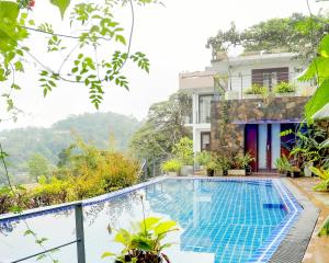 a villa with a swimming pool on a hill at Liselma Residence in Kandy